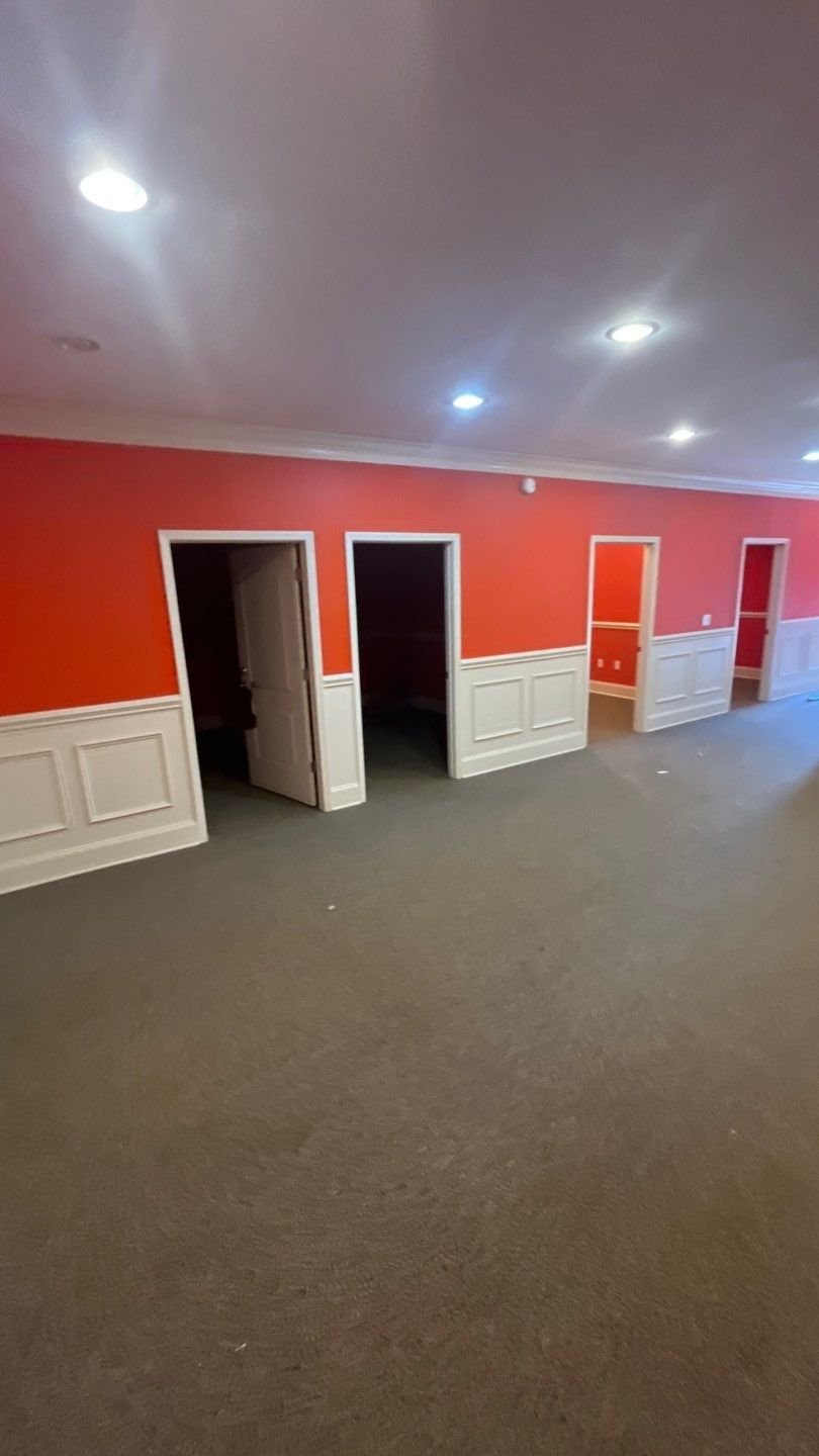 Refreshed common-area hallway with new paint, new trim, and lighting — a clean canvas for the next tenant or owner.